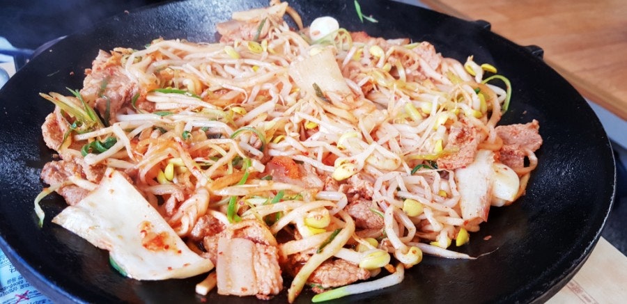 Adding kimchi